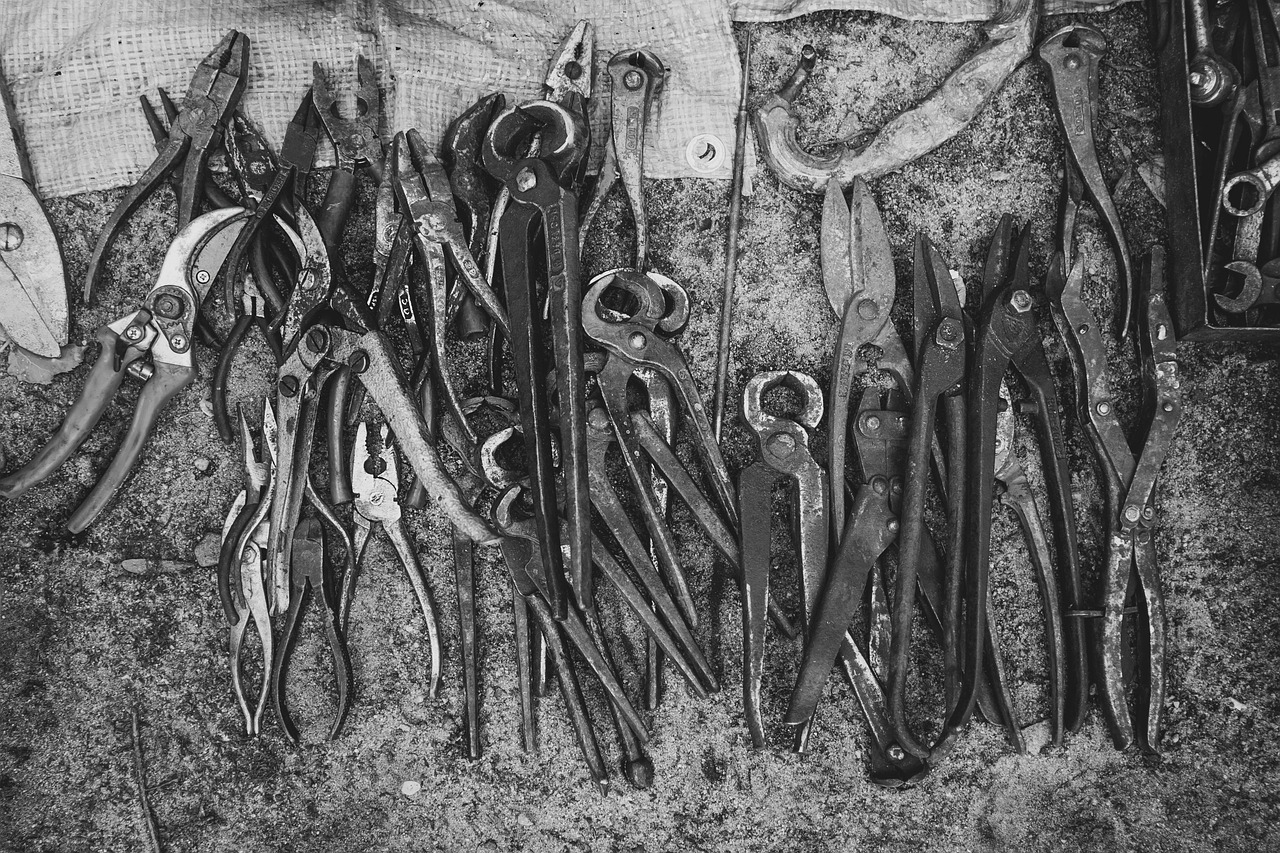 Black and white metal pincers - different tools for different jobs